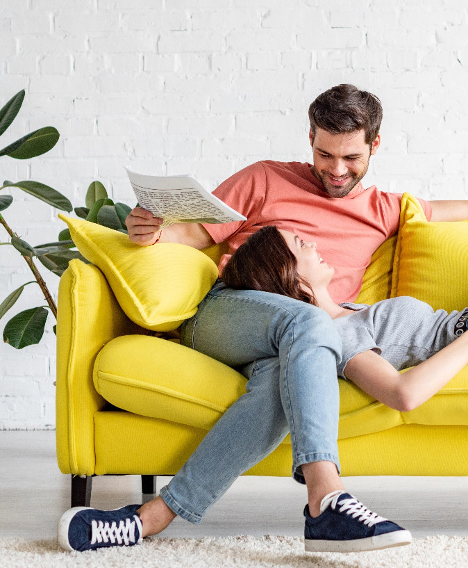 Couple laughing together in living room