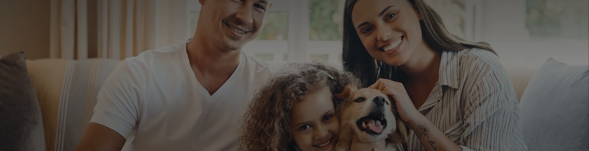 Happy family in living room with dog