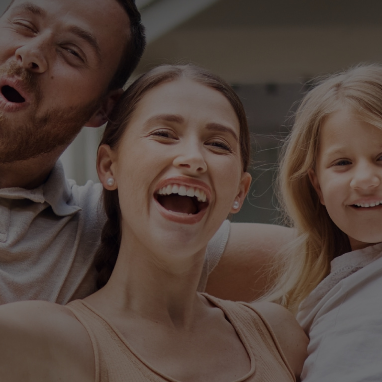 Happy family smiling outside