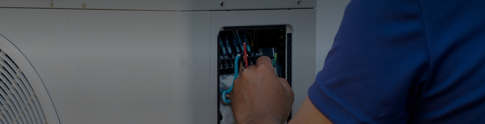 Man changing wire in installation