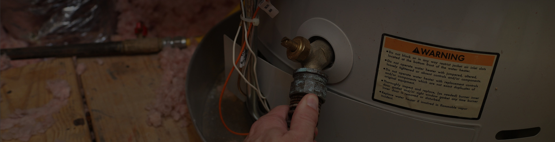 Man repairing hot water tank