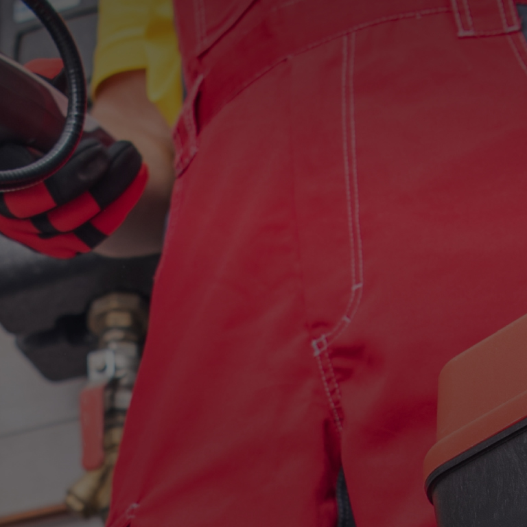 Man working witht tools wearing red